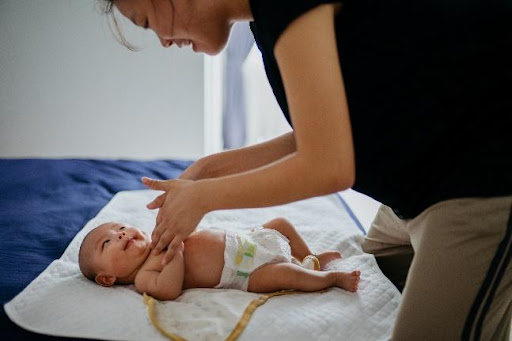 mother massaging her baby