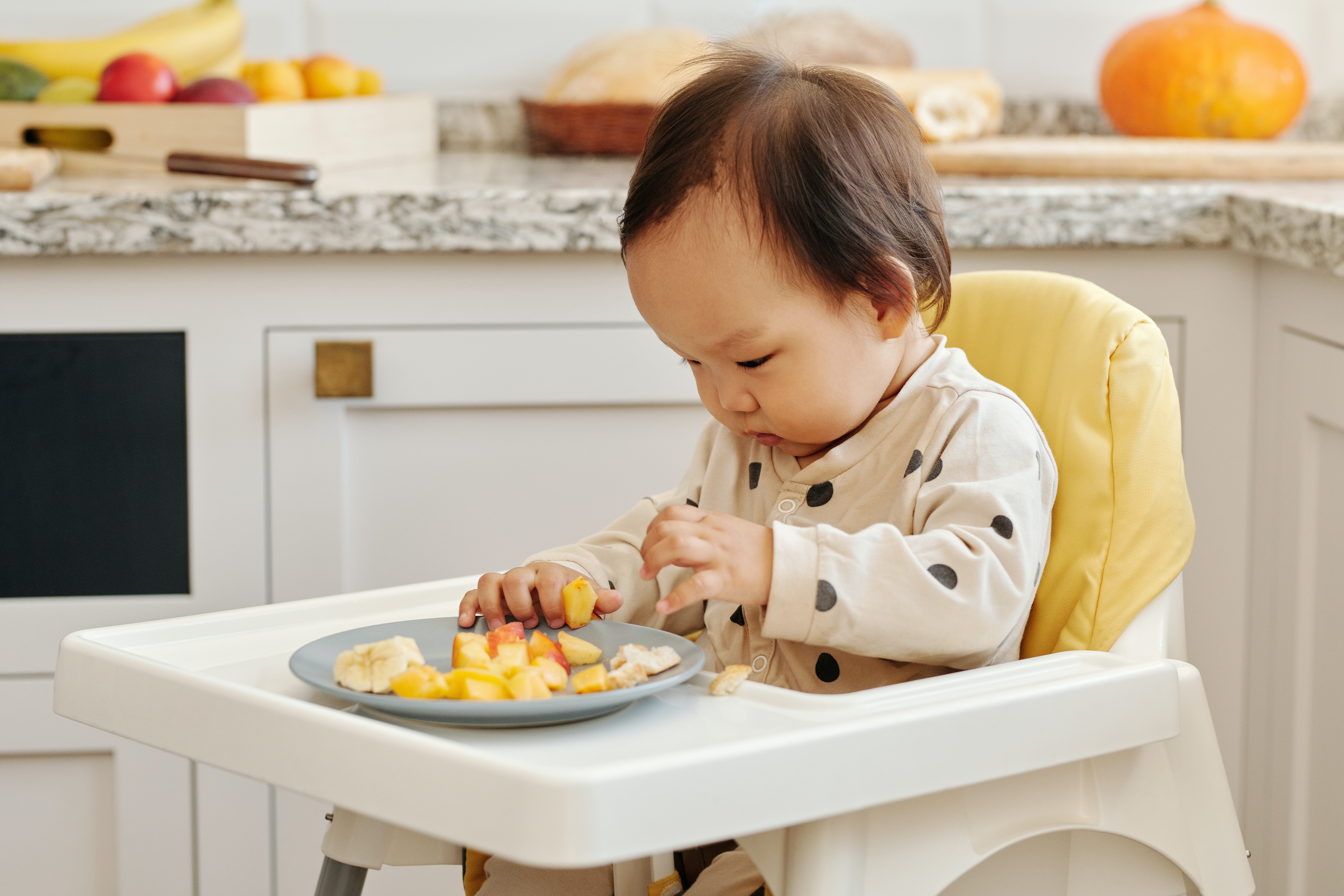 a baby investigating new foods and discovering fresh baby-led weaning meals.