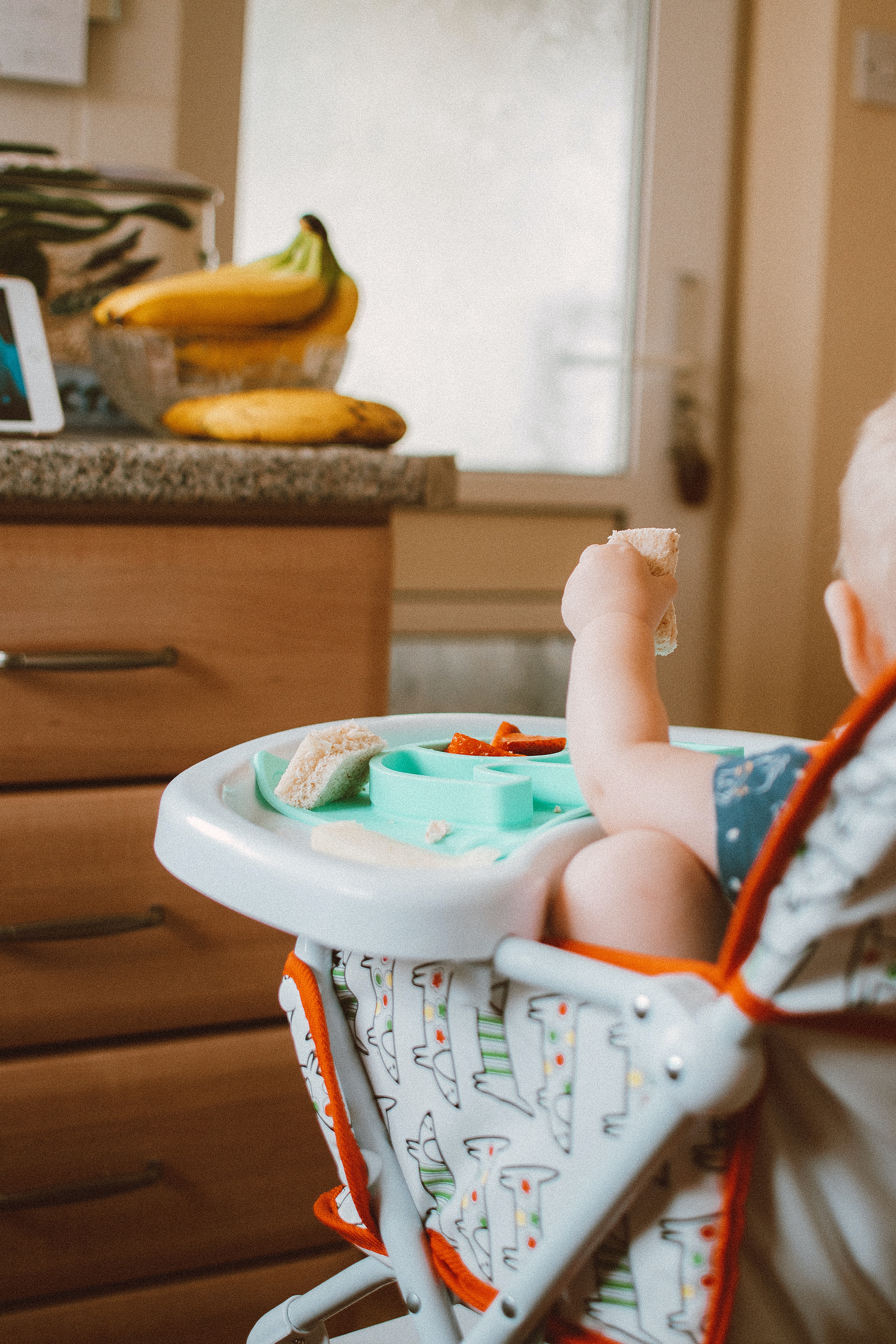 a baby is discovering the benefits of baby-led weaning by exploring new types of food.