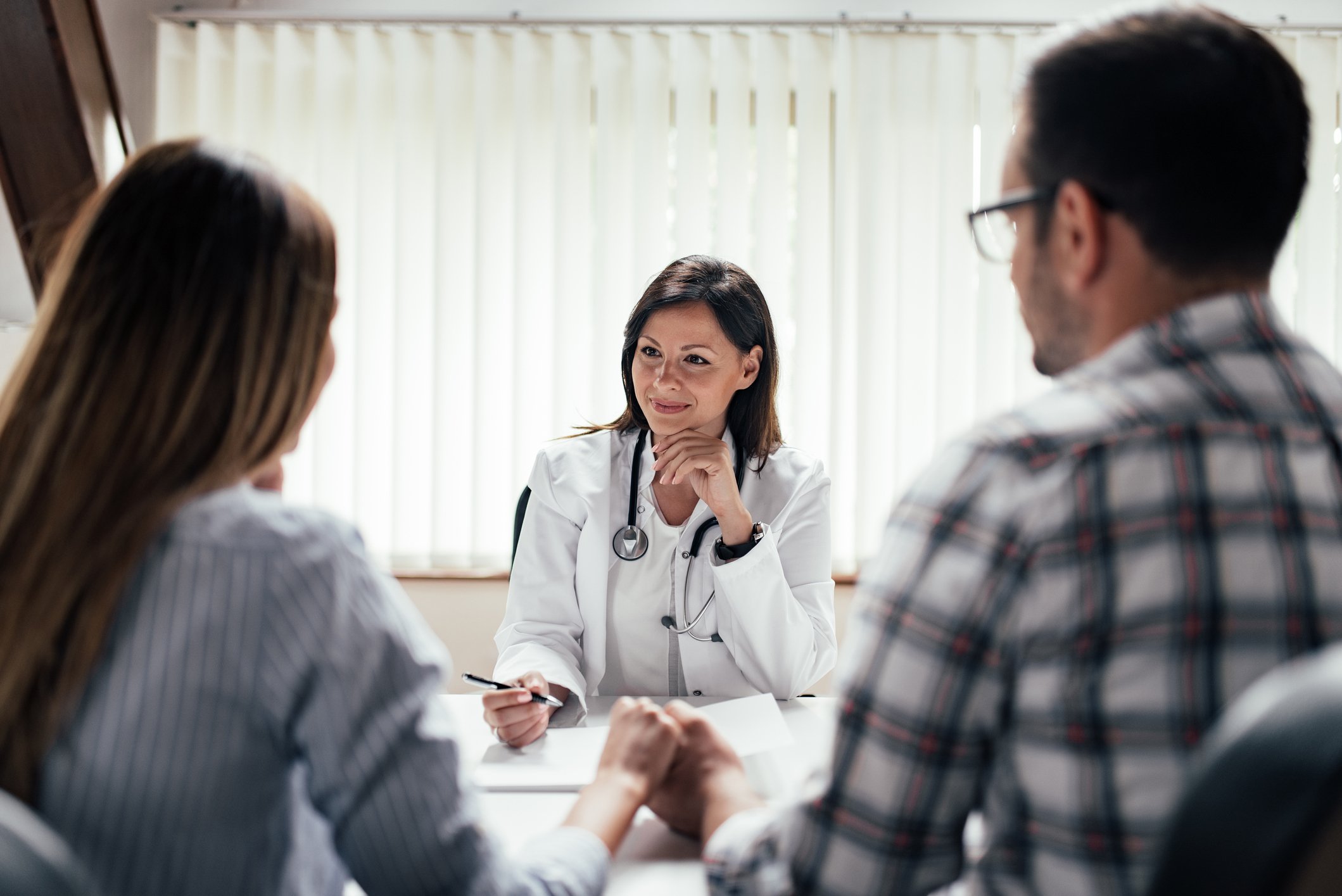 Couple speaking to a fertility specialist about how to increase fertility