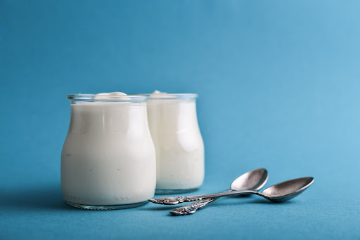 Two jars of Greek yoghurt with spoons. Greek yoghurt is ideal for healthy eating in pregnancy.