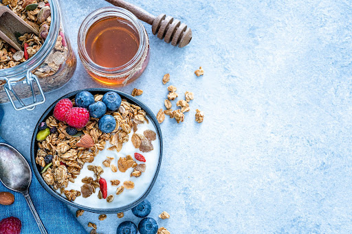 Yoghurt, granola, mixed berries and honey is a great food option during the first trimester of pregnancy.
