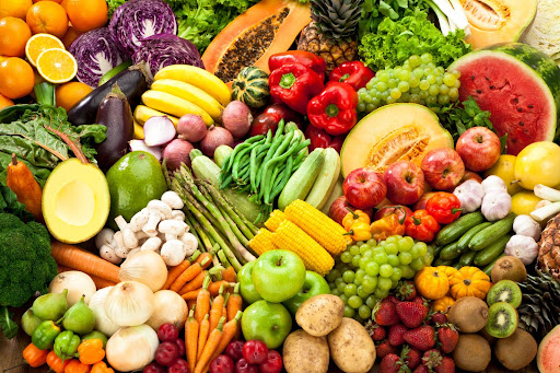 An array of colourful fruit and vegetables ideal for including in a healthy pregnancy diet.
