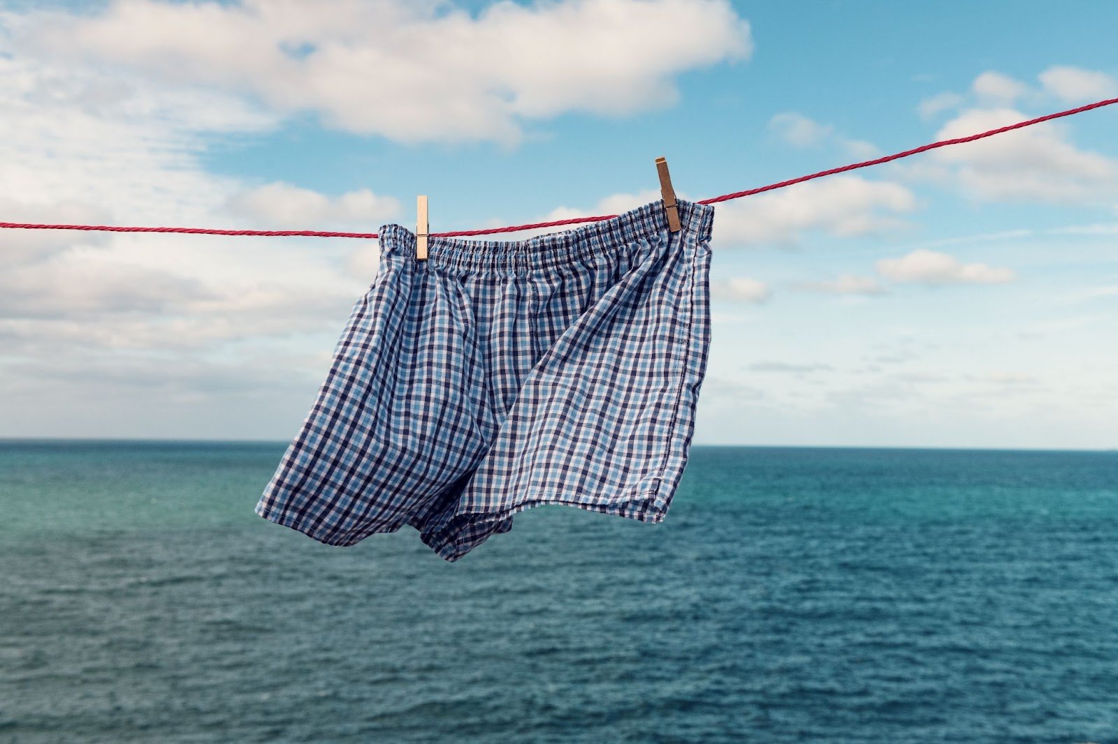 Boxer shorts on a washing line, blowing in the breeze next to the sea. Loose-fitting underwear can help improve sperm count.