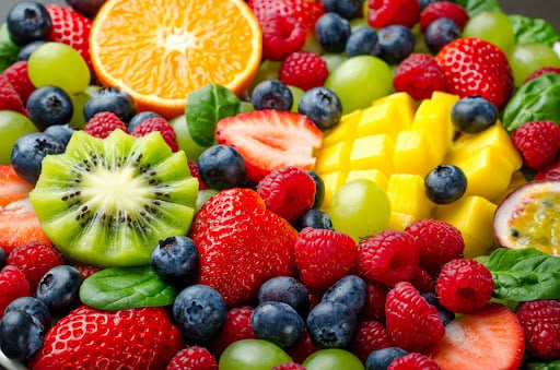 An assortment of pregnancy foods high in vitamin C, like kiwis, strawberries and oranges.
