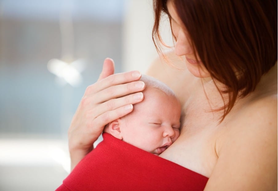 A mother learning how to soothe a colic baby.