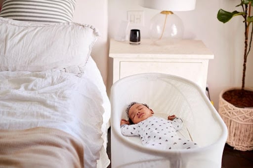 newborn baby sleeping in a cradle