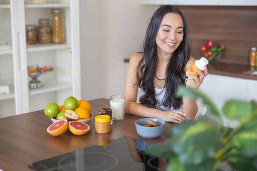 A woman takes a vitamin supplement during the first trimester of pregnancy.