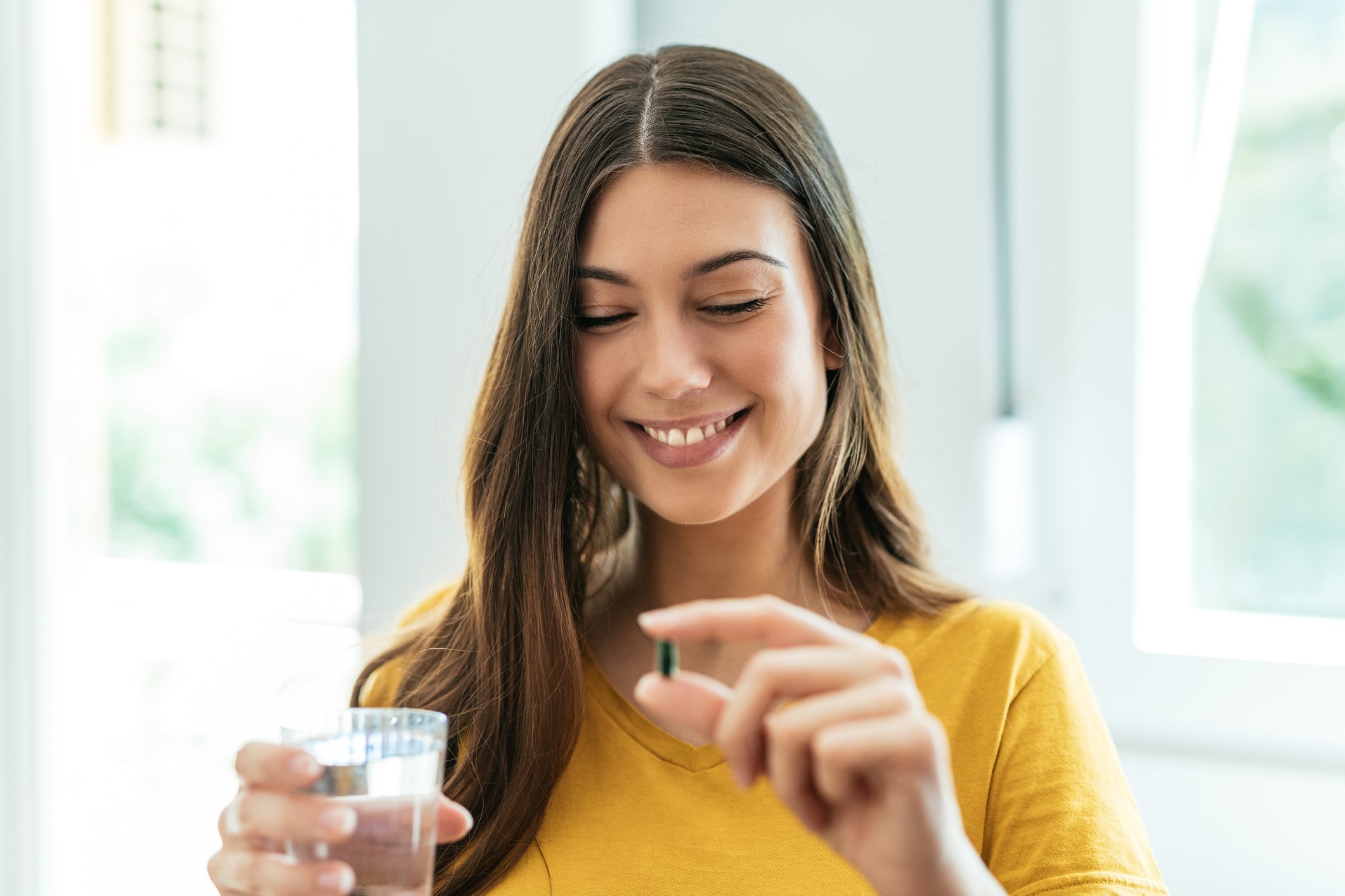 Young woman takes supplements to increase fertility