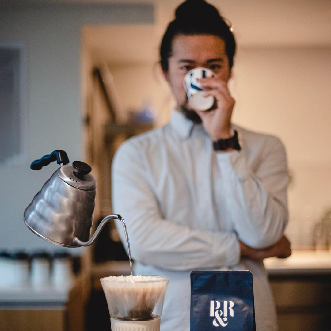 kettle floating in mid air whilst man enjoys a cup of P&R specialty coffee