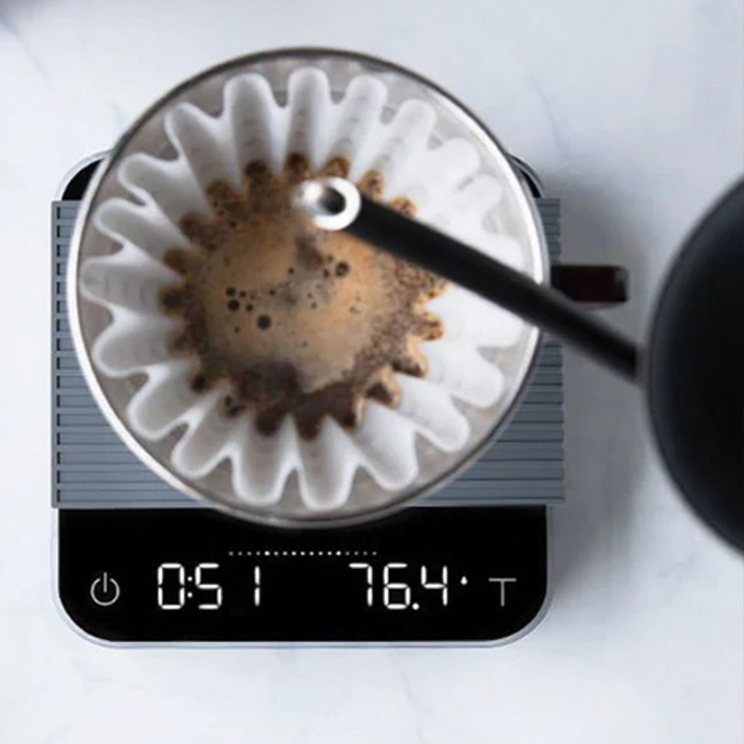 pouring coffee into a cup on the Acaia Pearl scale