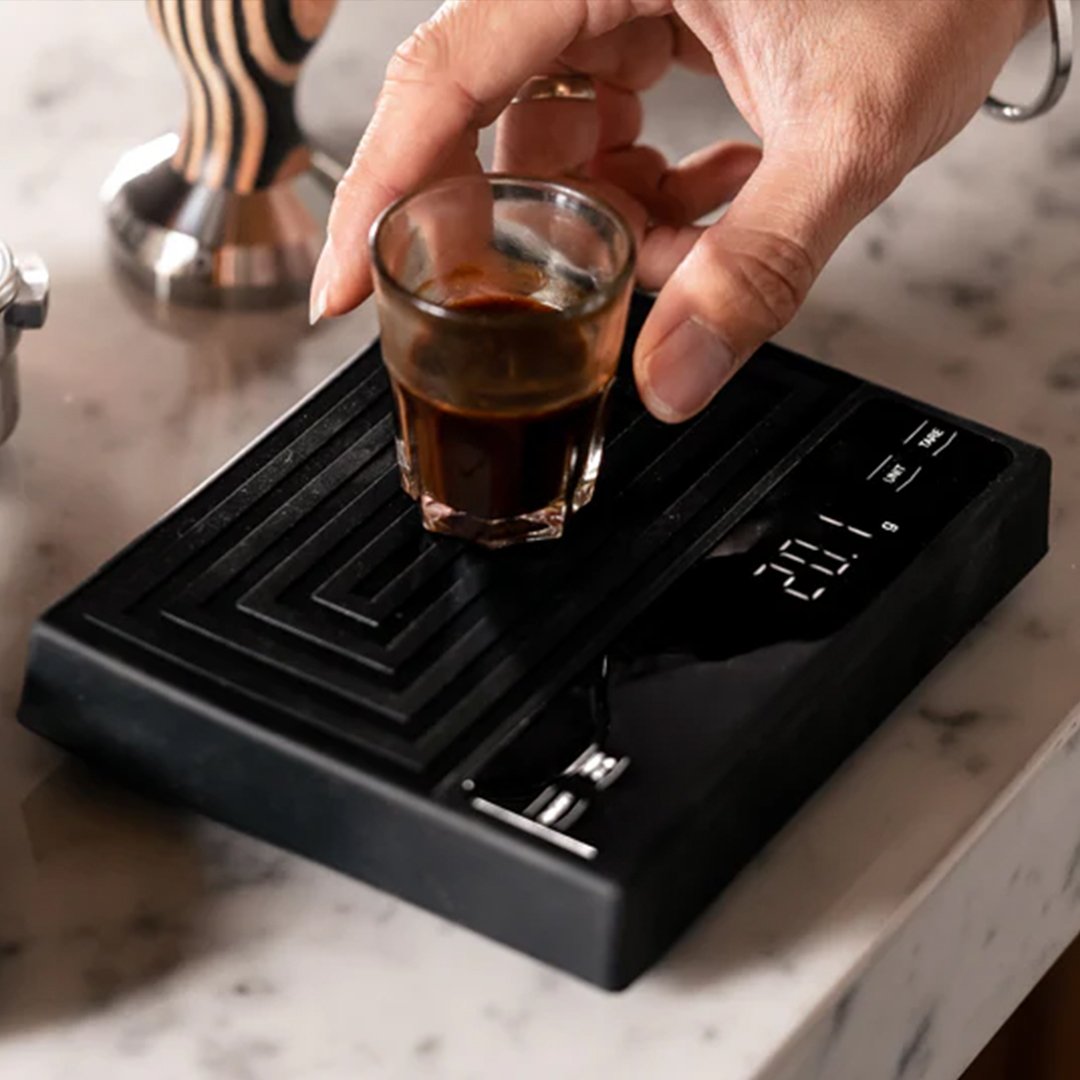 weighing coffee on Artisan Barista scale