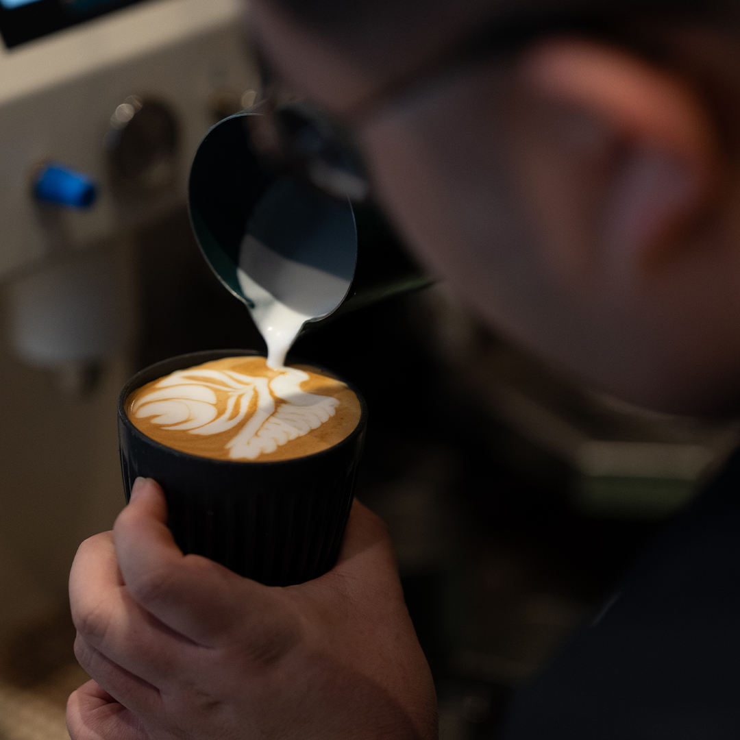 barista making latte
