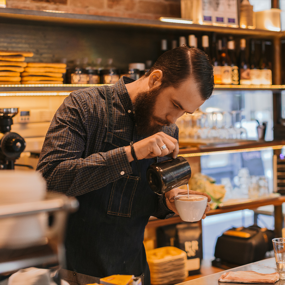 Barista preparing a delicious cup of coffee 