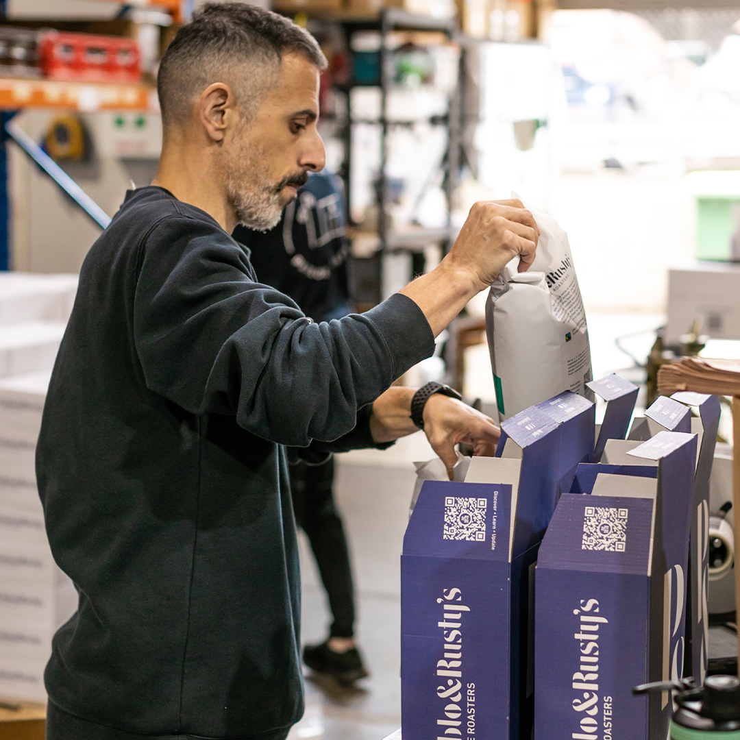 P&R staff putting coffee bags in the boxes ready for dispatch