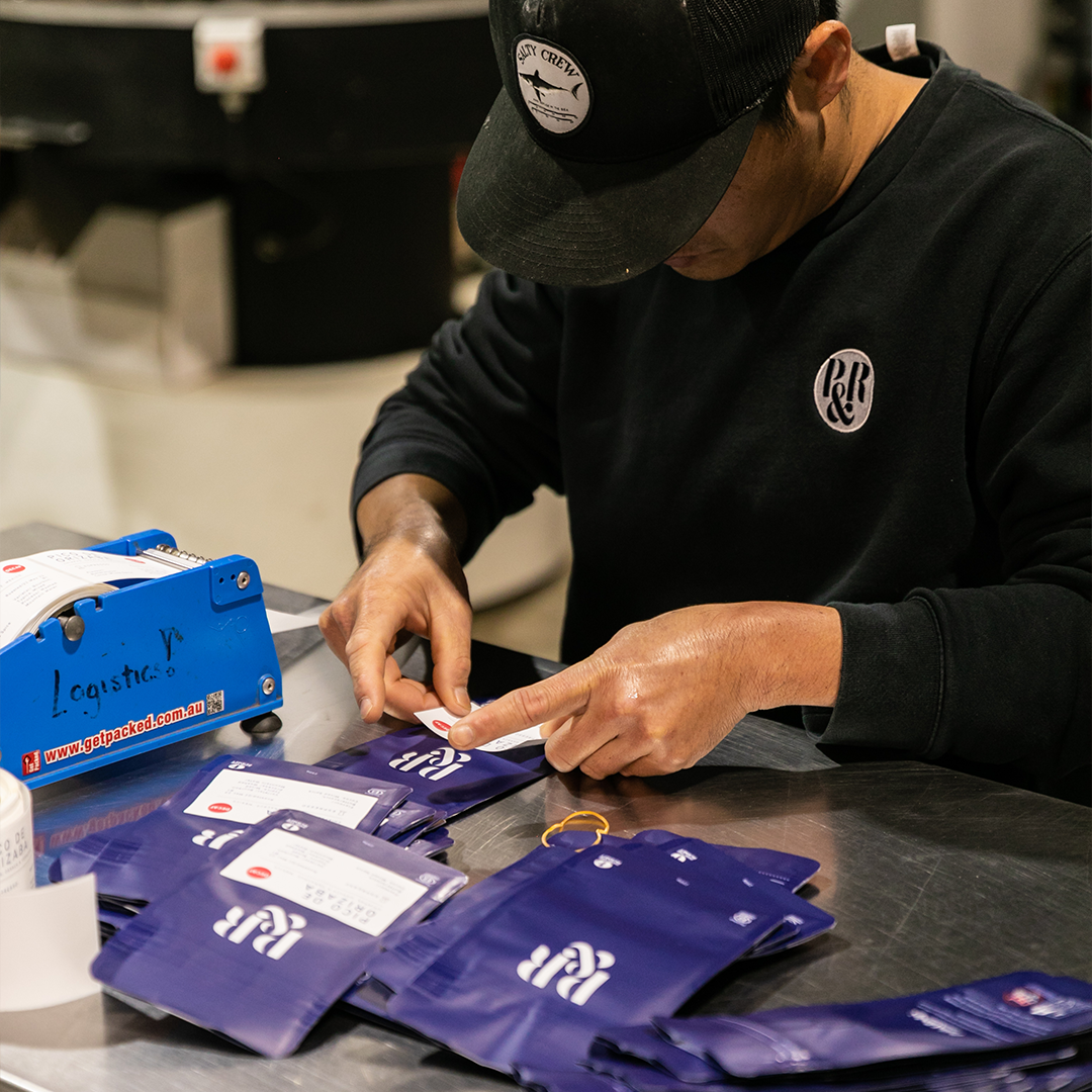 P&R Staff putting stickers on the coffee bags 