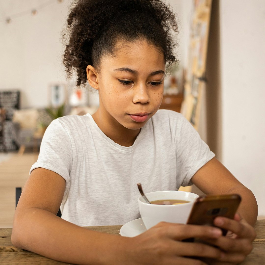 a kid having coffee