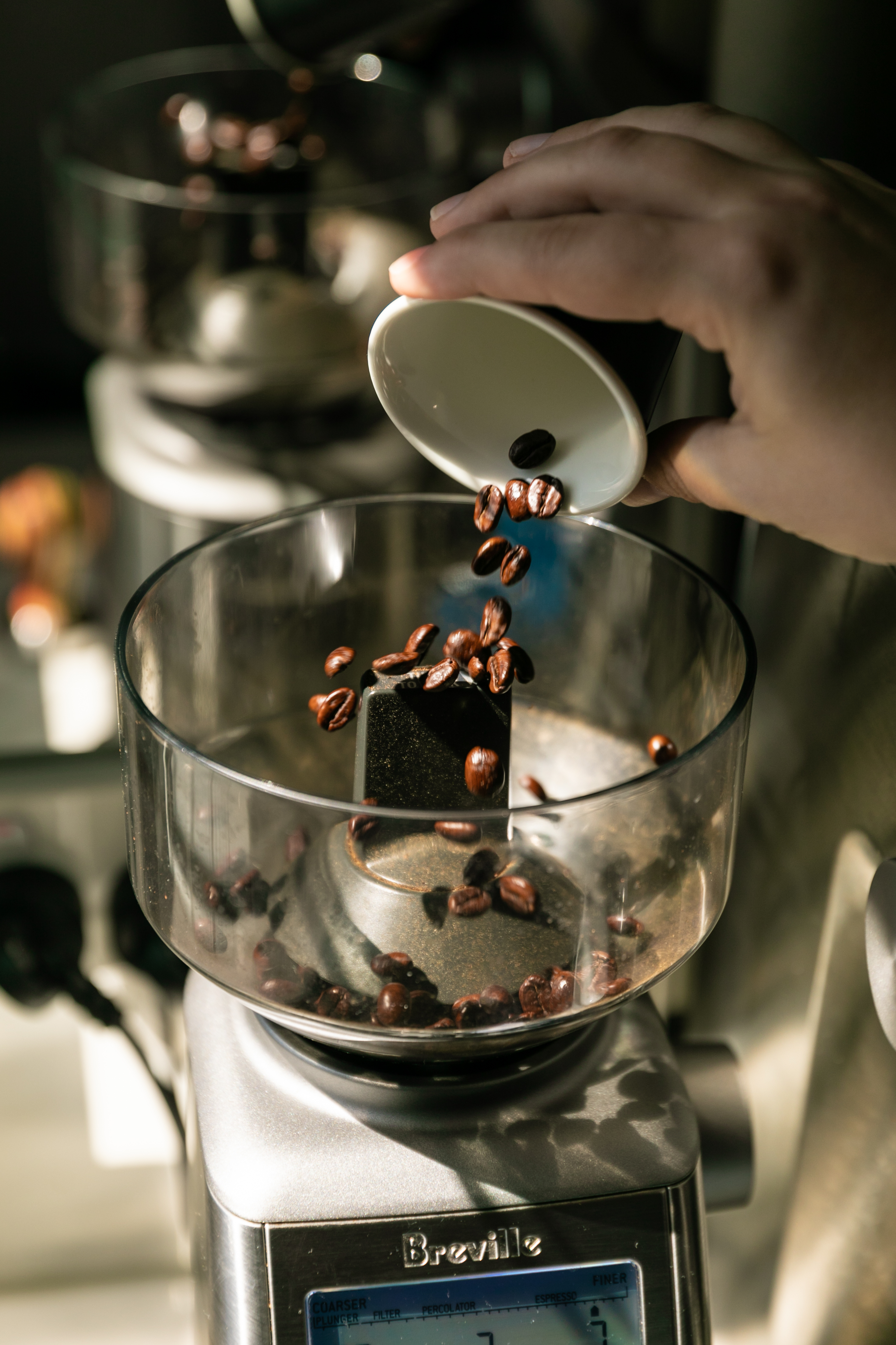 putting coffee beans into the grinder