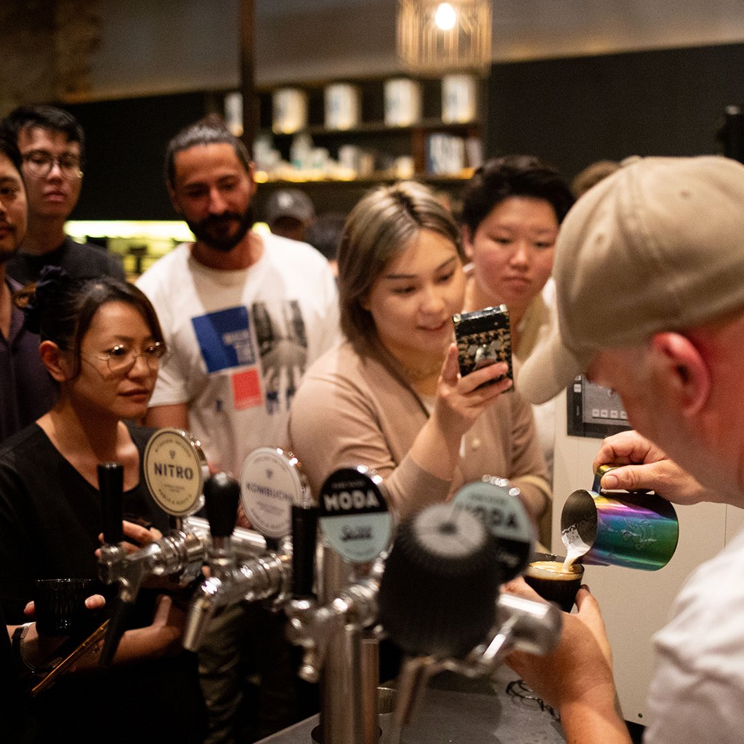 customers taking picture of a barista
