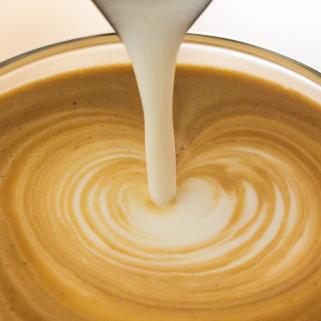 pouring milk into a flat white