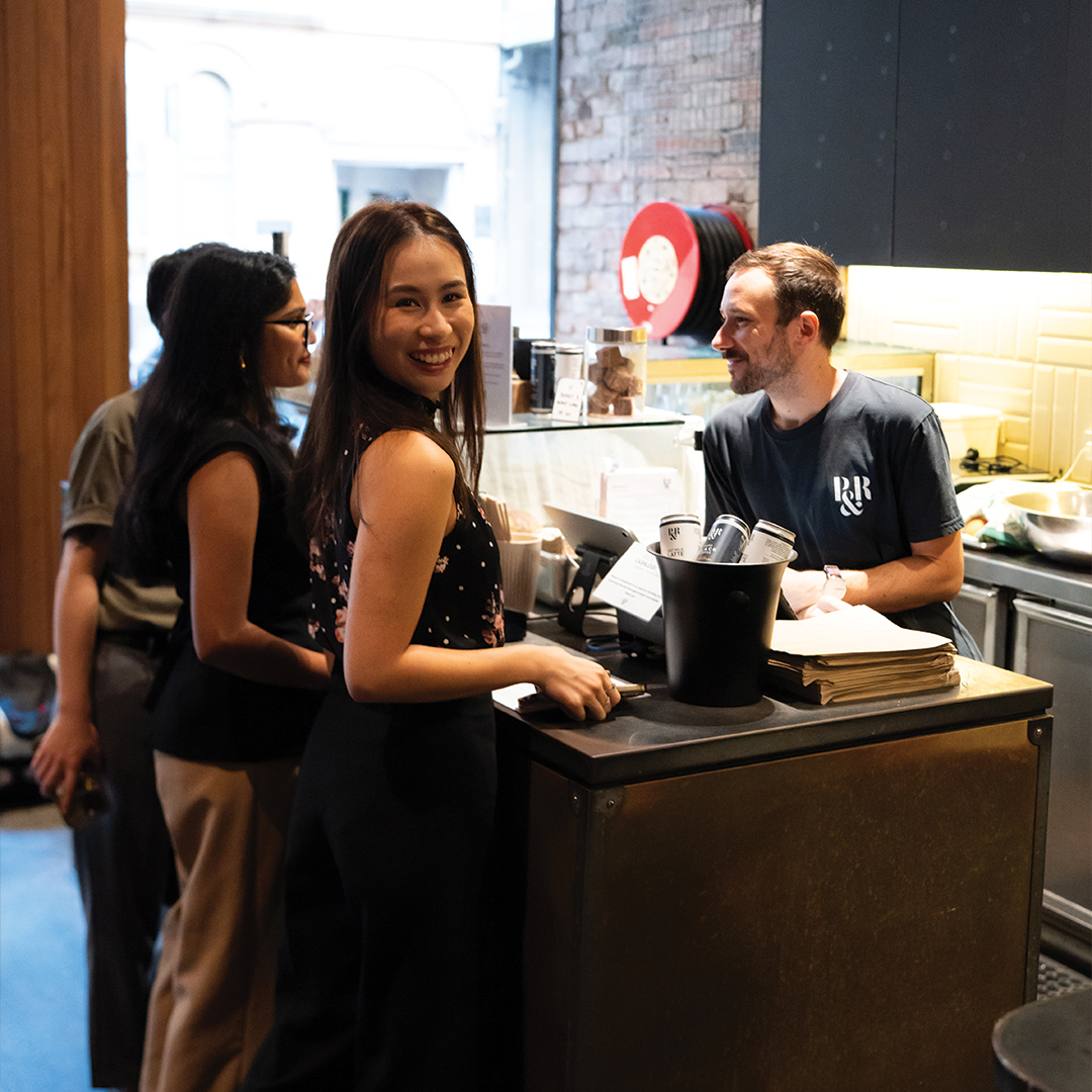 customer paying at a cafe counter