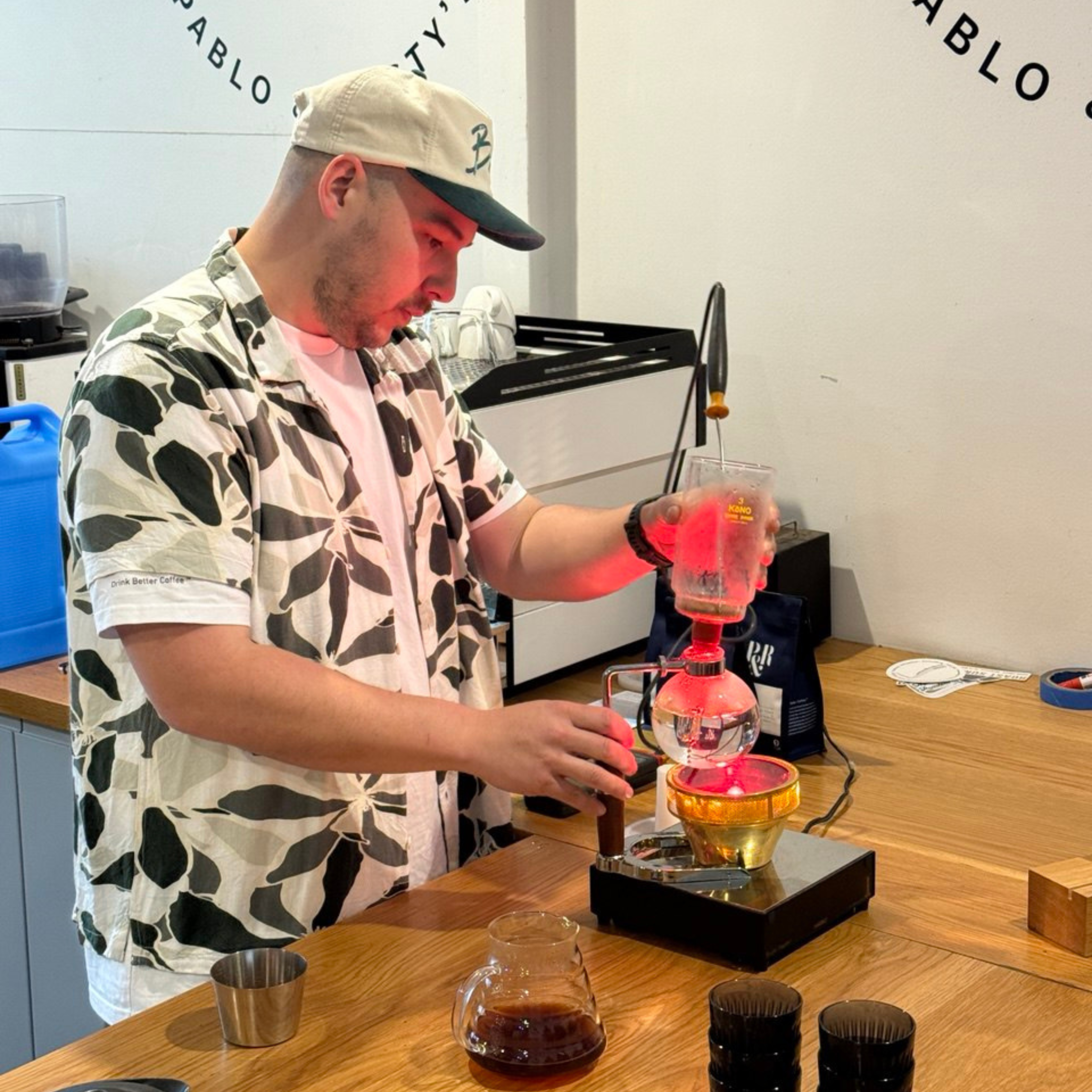 preparing coffee on a siphon brewer