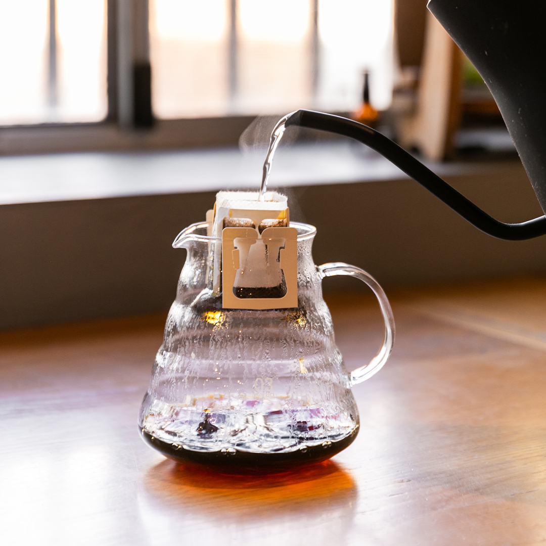 pouring hot water to a drip coffee