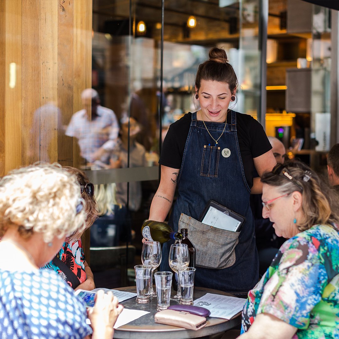 Cafe staff happily serving the customers