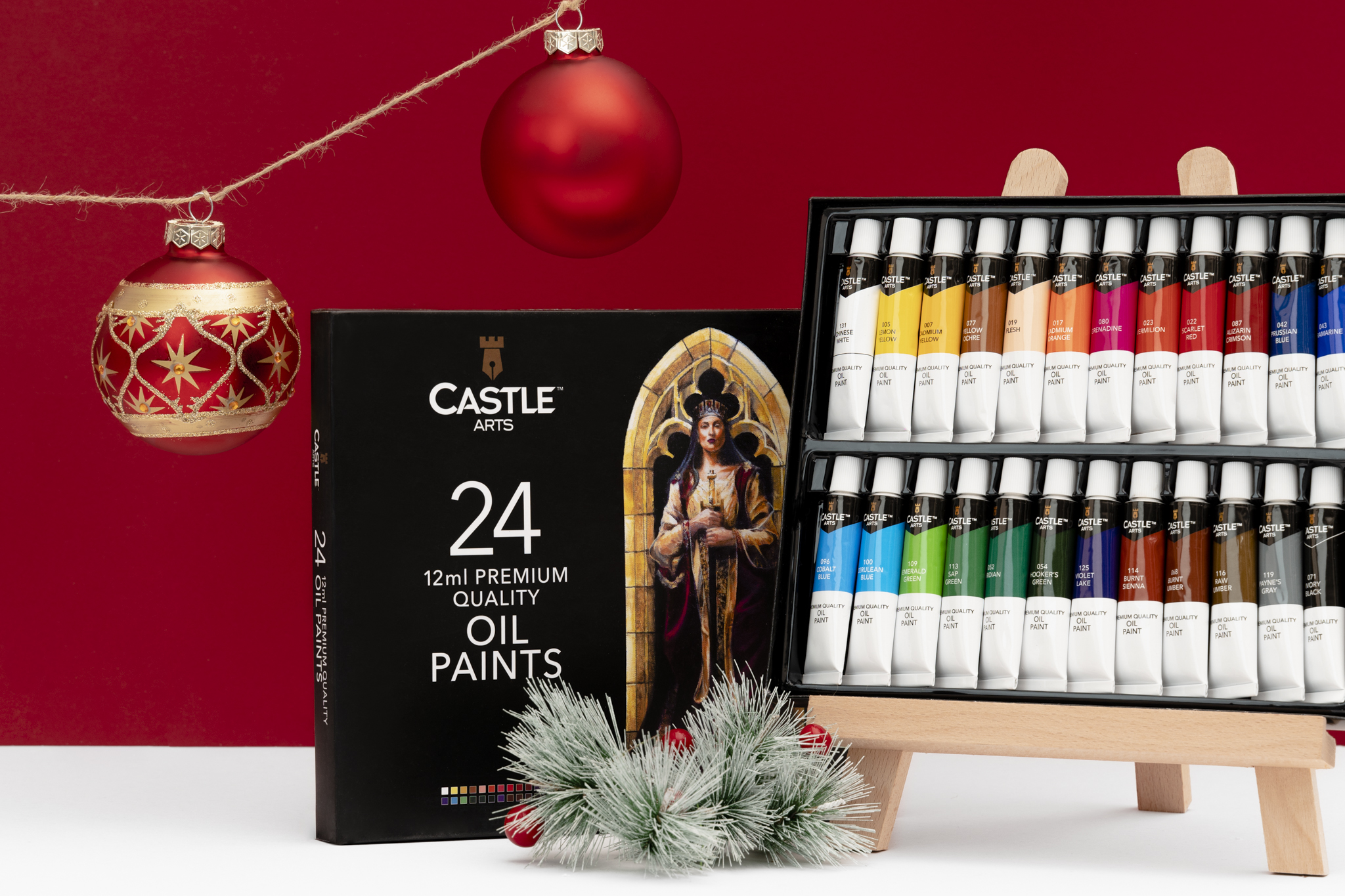 Castle Arts oil paints displayed with a festive backdrop.