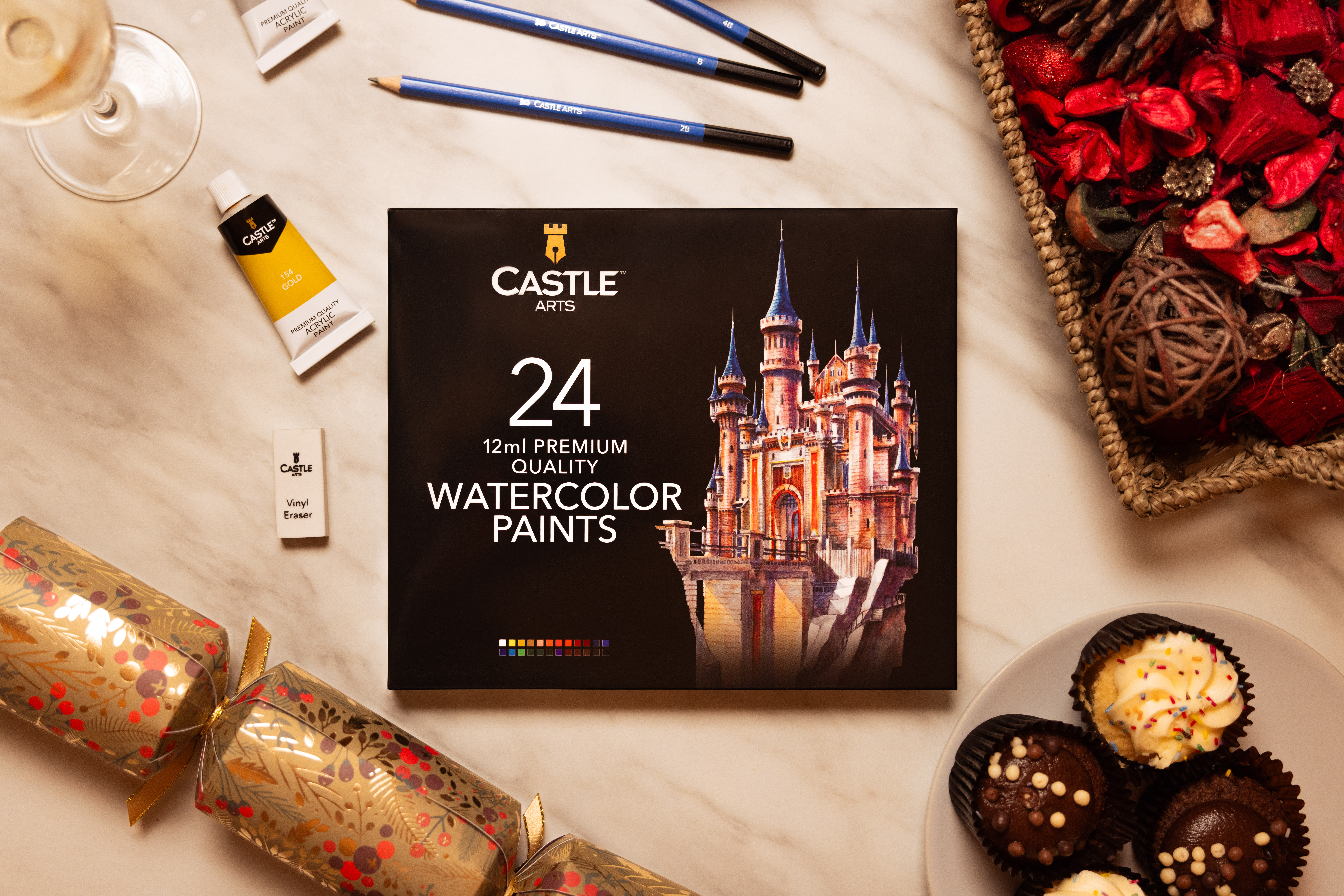 Castle Arts watercolour paints displayed against a festive backdrop.