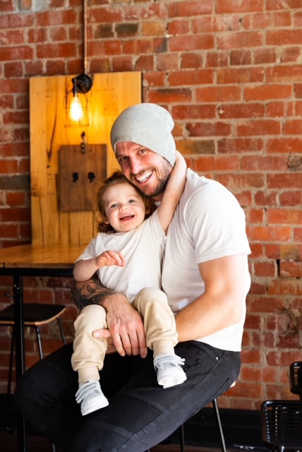 A person holding a baby
Description automatically generated with medium confidence