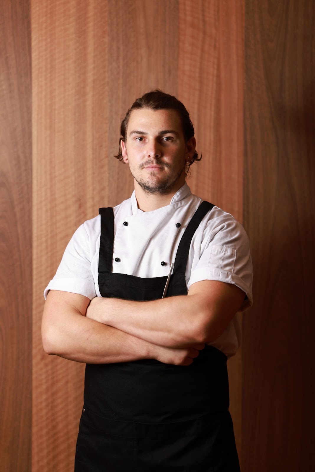 A person with his arms crossed
Description automatically generated with medium confidence