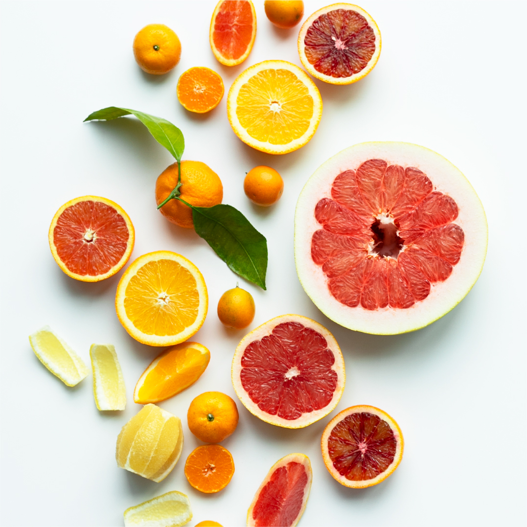 a selection of citrus on a white surface