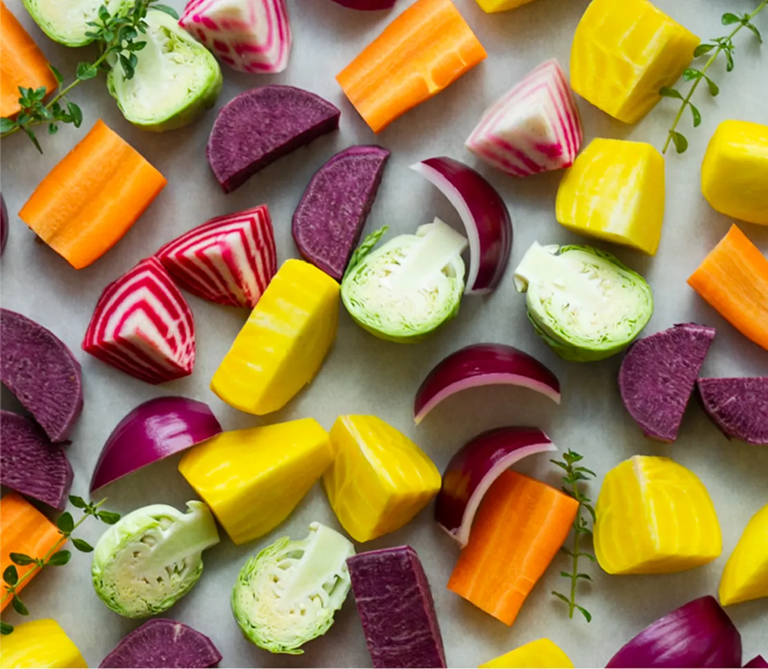 a tray of cut vegetables ready for roasting