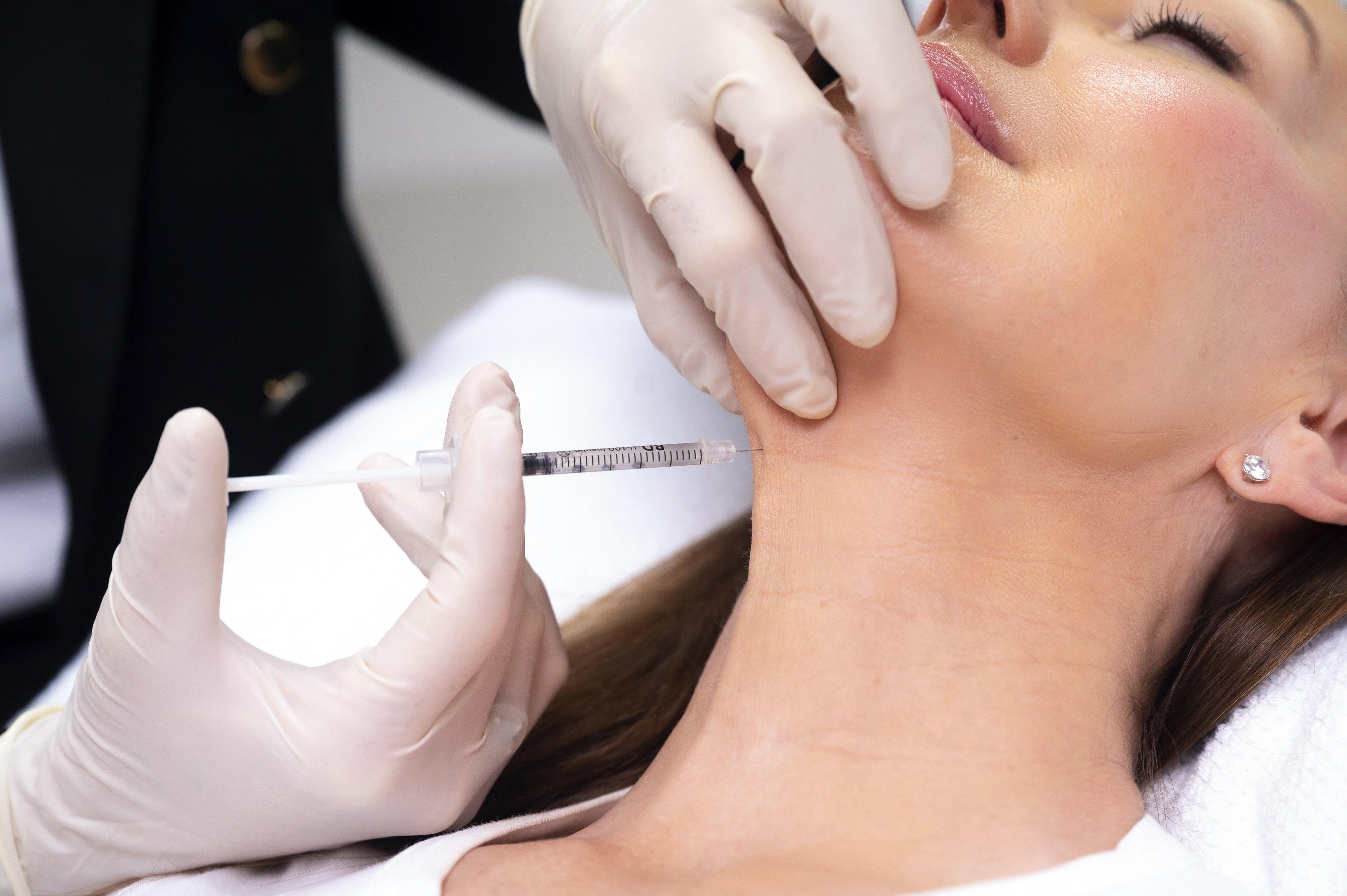 Woman receiving cosmetic injections in the neck at The Clinic Bondi