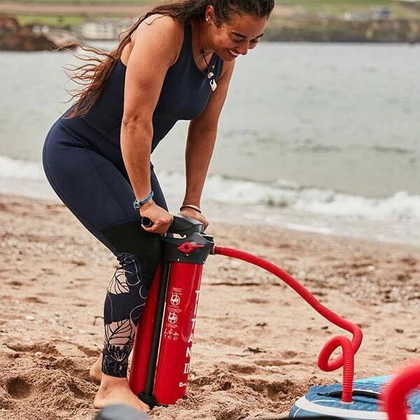 woman pumping up inflatable paddle board using Titan II Sup pump