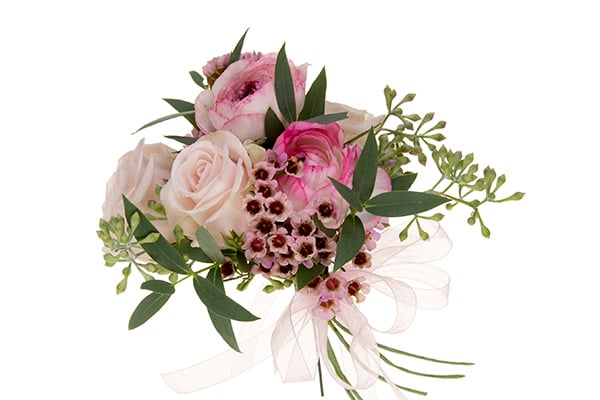 A petite line corsage mixes two kinds of roses with wax flower, seeded eucalyptus, and Italian ruscus, then is finished with pale pink sheer ribbon.