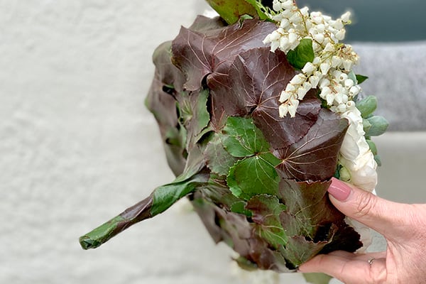 The handle and back of a bridal bouquet