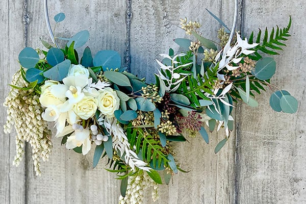 Bridal bouquet created on a hoop and meant to be carried over the arm.