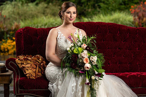 Seated bride holding a bespoke bridal bouquet