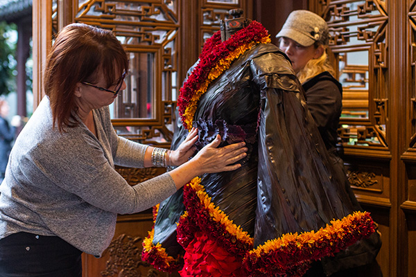 FDI Instructors Carolyn Catron and Jeri Barr finish the details on their floral Chinese wedding gown for the Ninth Moon Celebration at Lan Su Chinese Garden in Portland, Oregon.