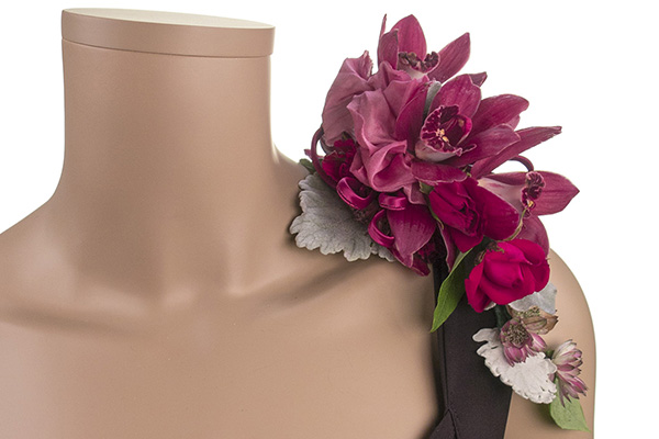 A beautiful cranberry colored corsage mixes orchids with Dusty Miller and other delicate blooms.