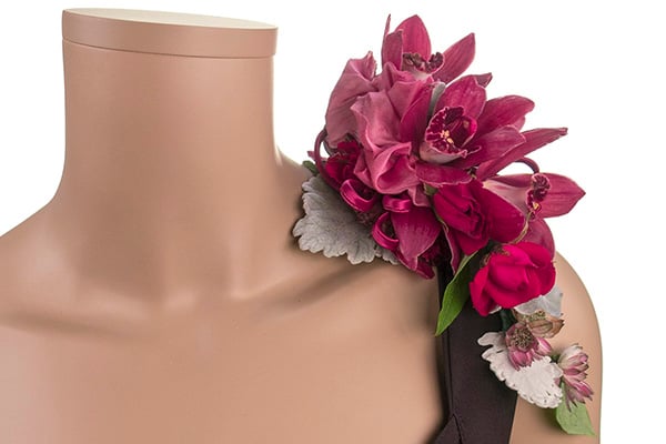 A beautiful cranberry colored corsage mixes orchids with Dusty Miller and other delicate blooms.