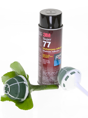 Cover the handle of the bouquet holder using spray glue and galax leaves.