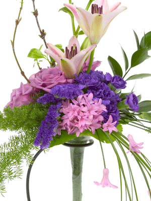 Add lavender roses on one side, moon shade mini carnations on the other side, and purple statice in the front of the bouquet.