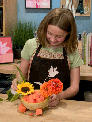 Cut flowers like sunflowers and zinnias short and insert them into the foam cubes.