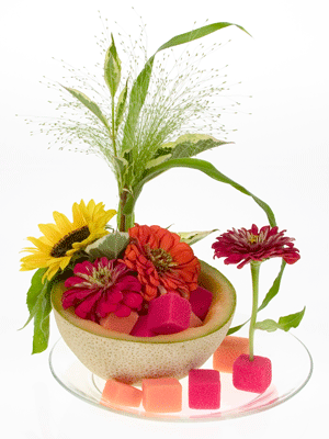 Wedge foam cubes under the melon rind to hold the design in place.