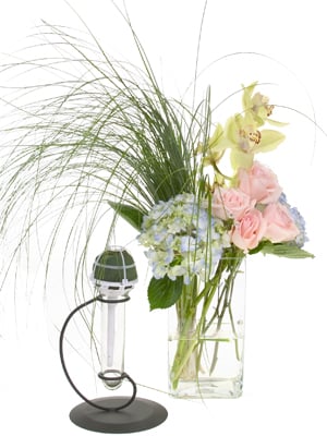 Materials for this bouquet include a straight handle bouquet holder, bear grass, hydrangea, roses, cymbidium orchids, and dendrobium orchid florets.