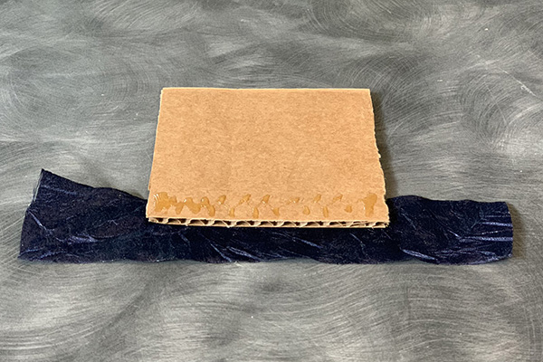 Glue ribbon to cardboard using OASIS Floral Adhesive.