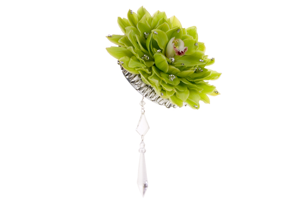 A magical bridal bouquet created from Cymbidium orchid blossoms has a perfect bloom in the middle, is enhanced with silver galax leaves, and adds crystals and rhinestones for bling.